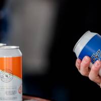 A guest holds a can of Lake and Valley lemonade